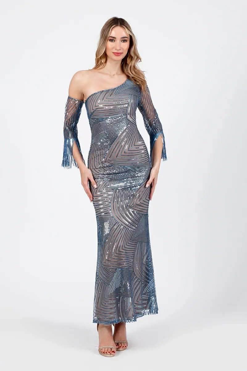 maxi forema me pagietes kai enan wmo miss vanity (4) Woman in a blue-gray one-shoulder sequined gown with fringe sleeves, posing against a light background that emphasizes the dress's shine and pattern.