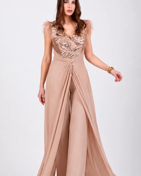Model wearing a blush pink jumpsuit with a sequined lace bodice, feathered shoulders, and a draped wrap waist.