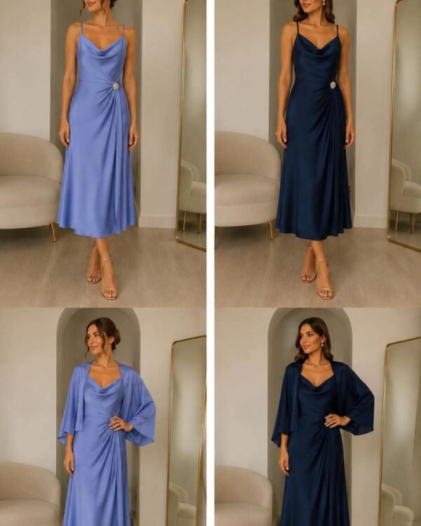 Model wearing a light blue satin midi dress with a draped wrap detail and a jeweled waist embellishment, standing in a showroom.